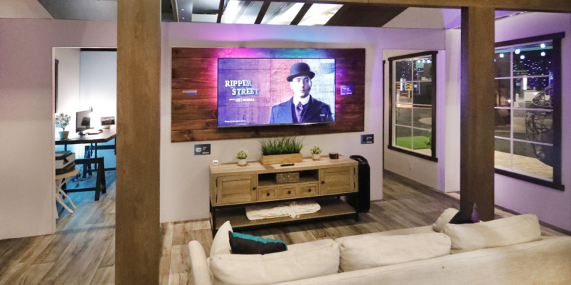 TV in living room with a couch and entertainment center