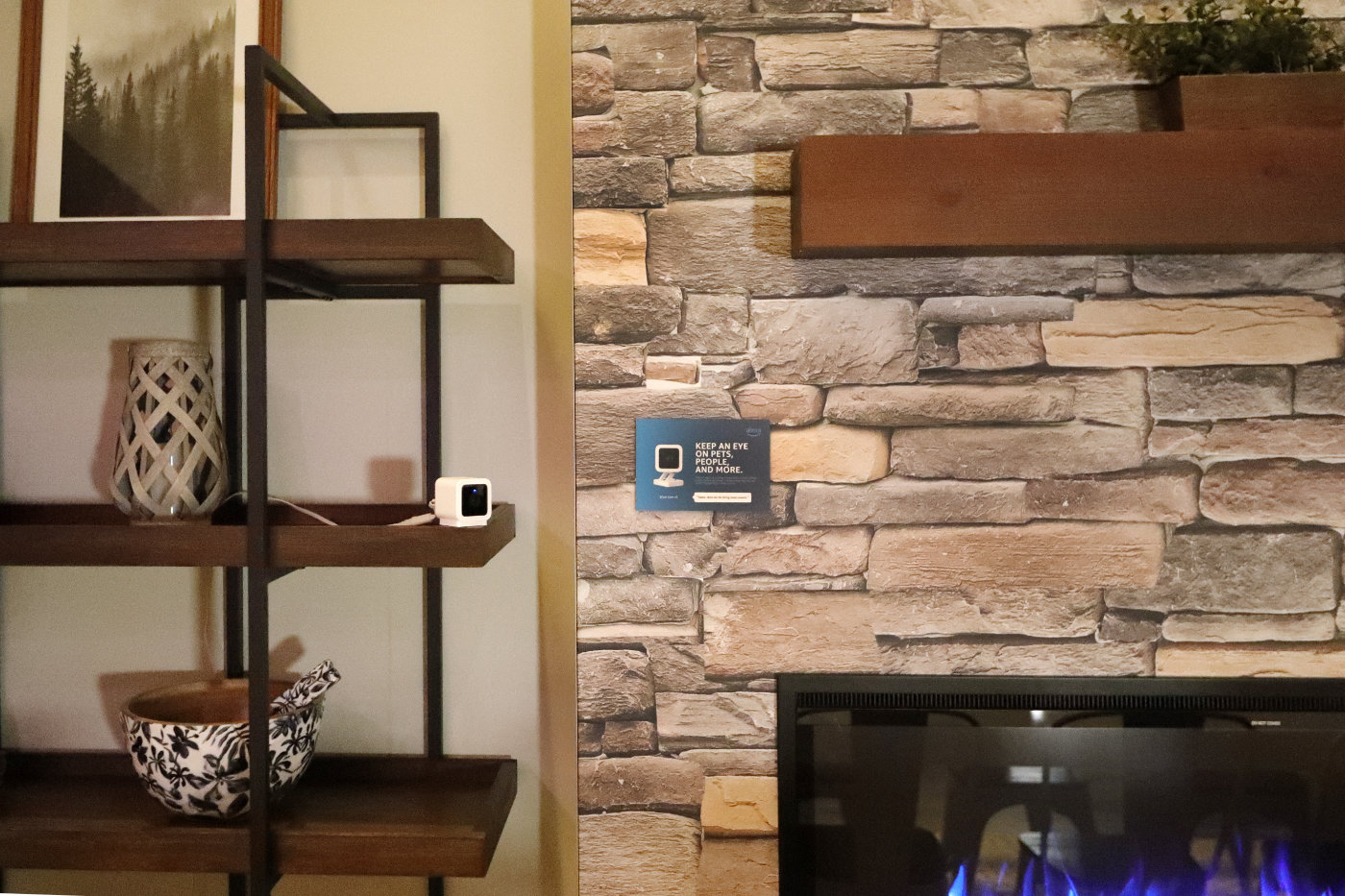 An Alexa home camera is set up on a book shelf.