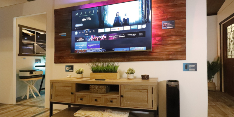 A TV and entertainment center with various Alexa tech on them