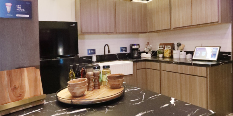 A kitchen with 4 sconces that have smart bulbs in them that can change color