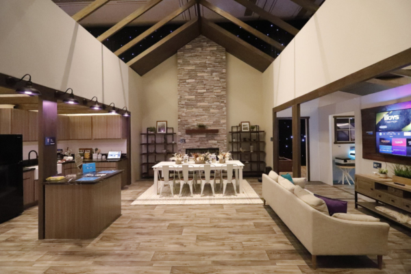 Wideshote of the living room, dinning room, and entertainment area showing off the vaulted ceiling